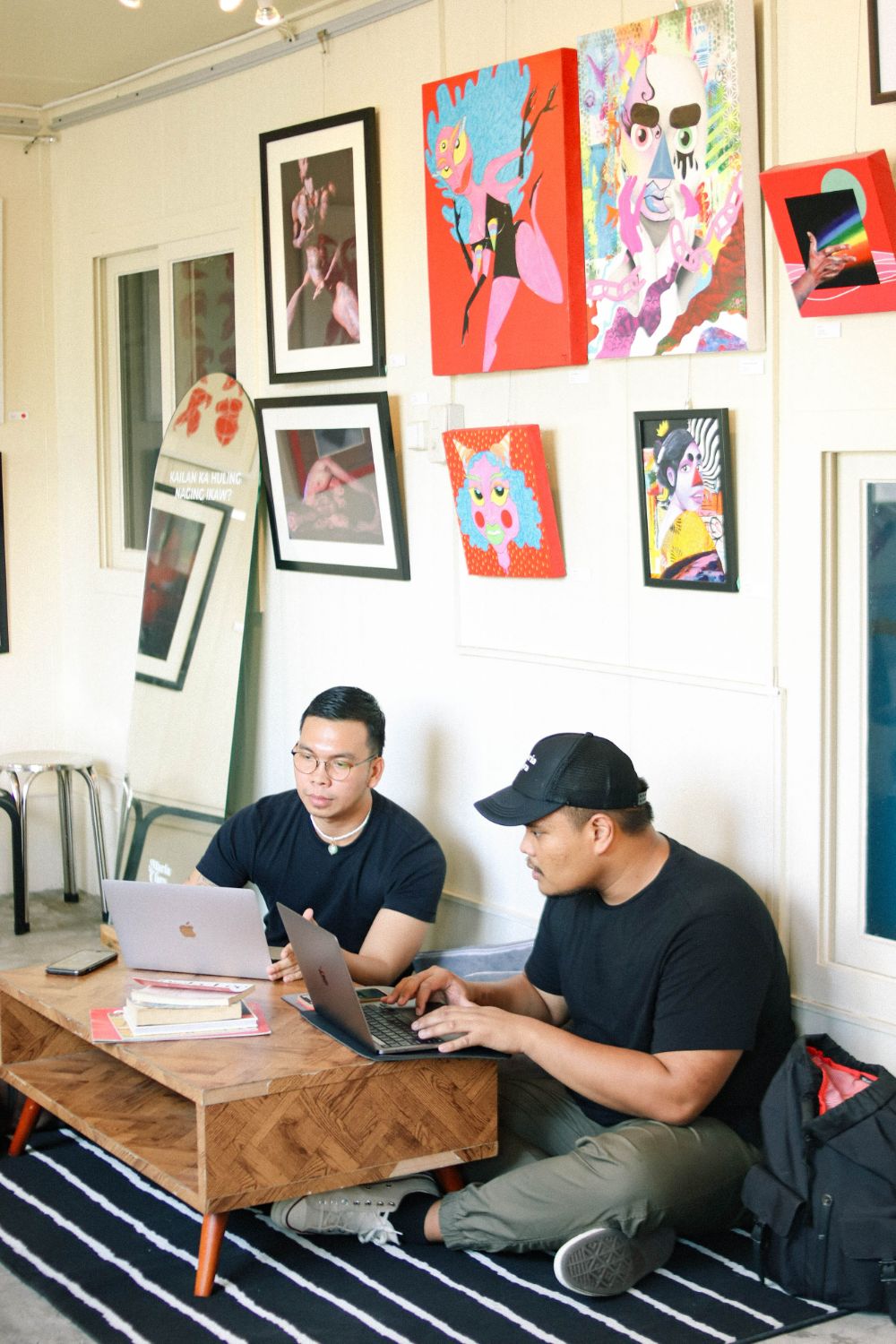 Two people seated while working at Maria Clara Cafe