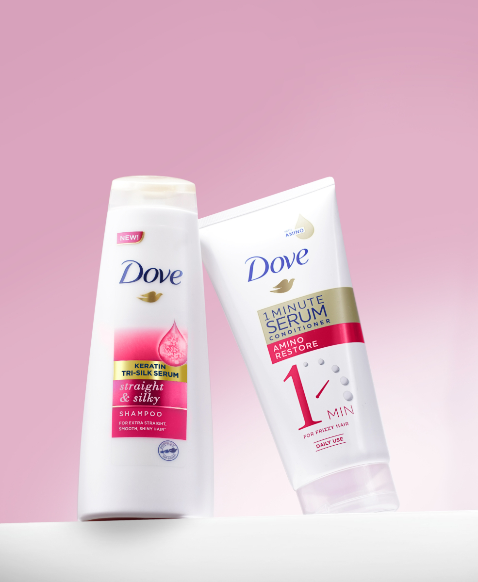Two bottles of Dove 1 Minute Serum Amino Restore Conditioner and Dove Straight & Silky Shampoo.