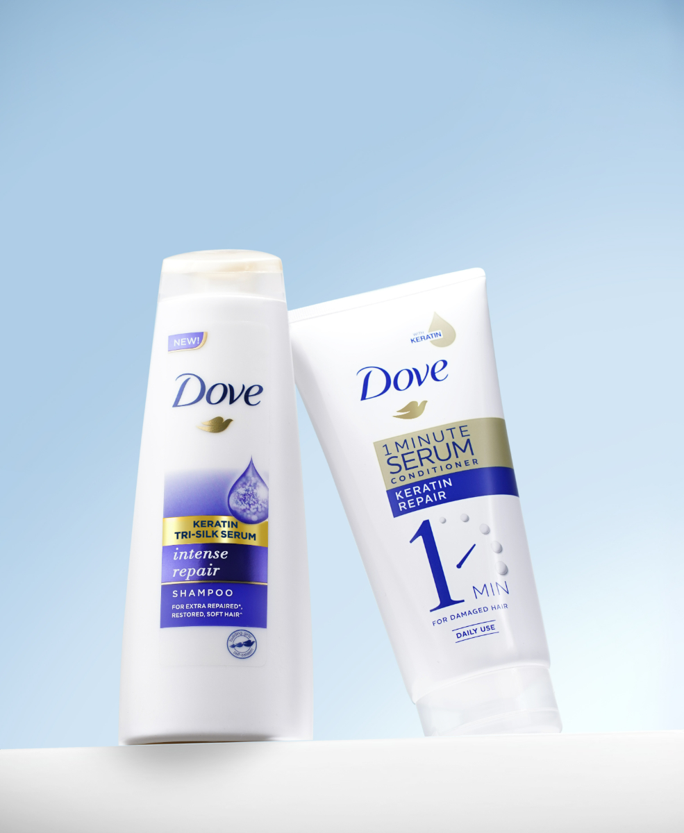 Two bottles of Dove 1 Minute Serum Conditioner and Dove Straight & Silky Shampoo Intense Repair Shampoo.