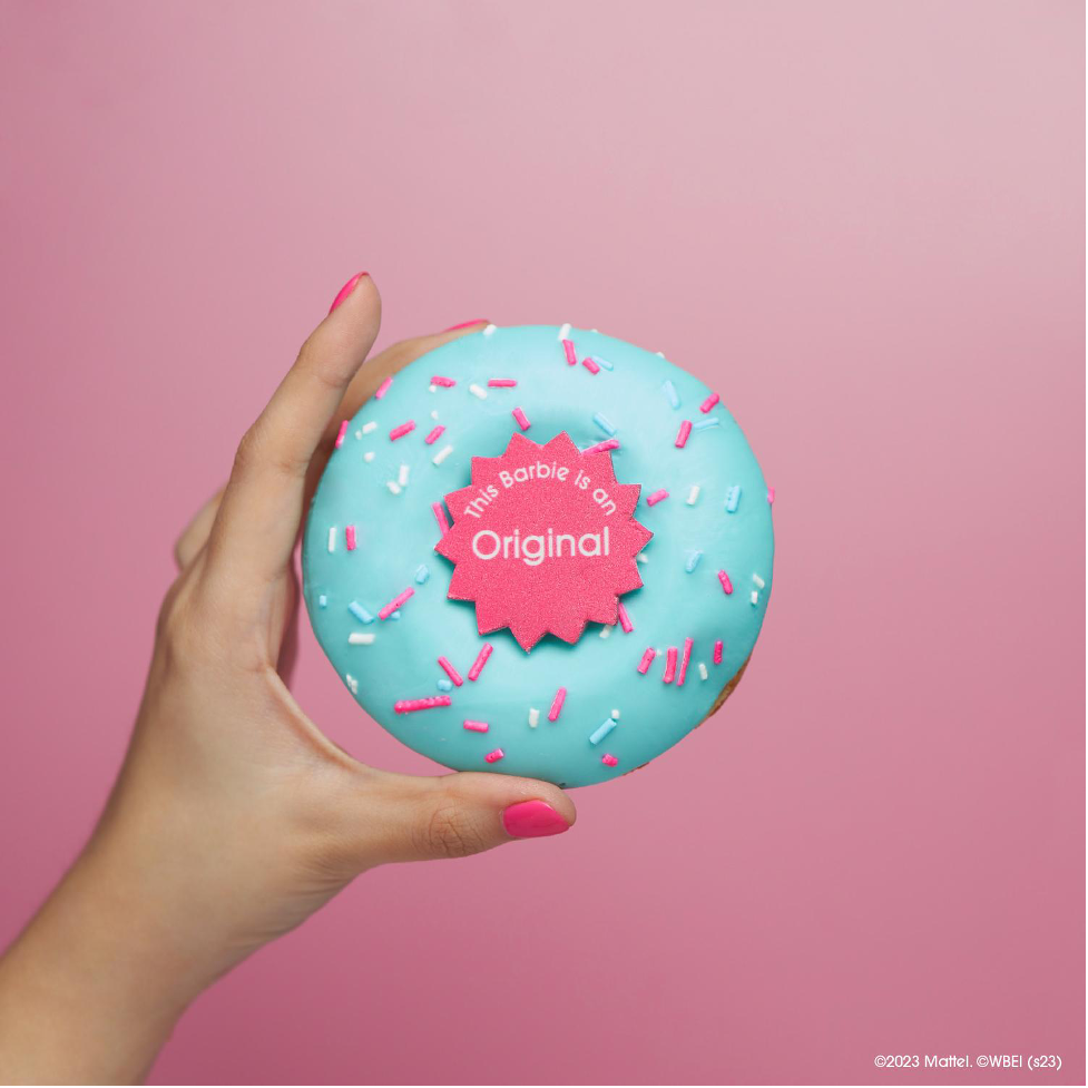 Barbie™, the Original, the Dreamer and the Girl Boss doughnut is a teal, bubblegum-flavored ring doughnut topped with a Barbie candy topper, and pink and white sprinkles.
